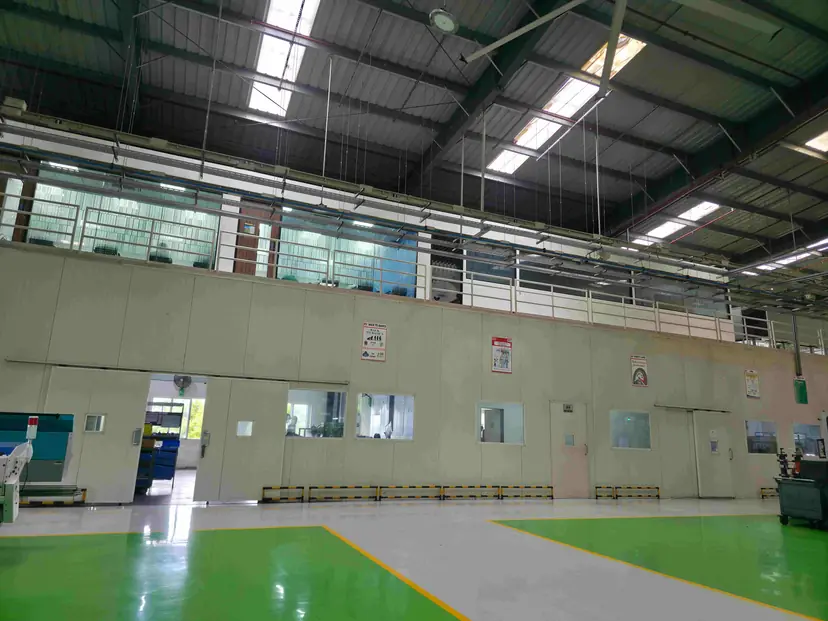 Fabricated structural steel mezzanine floor above an epoxy-coated production hall
