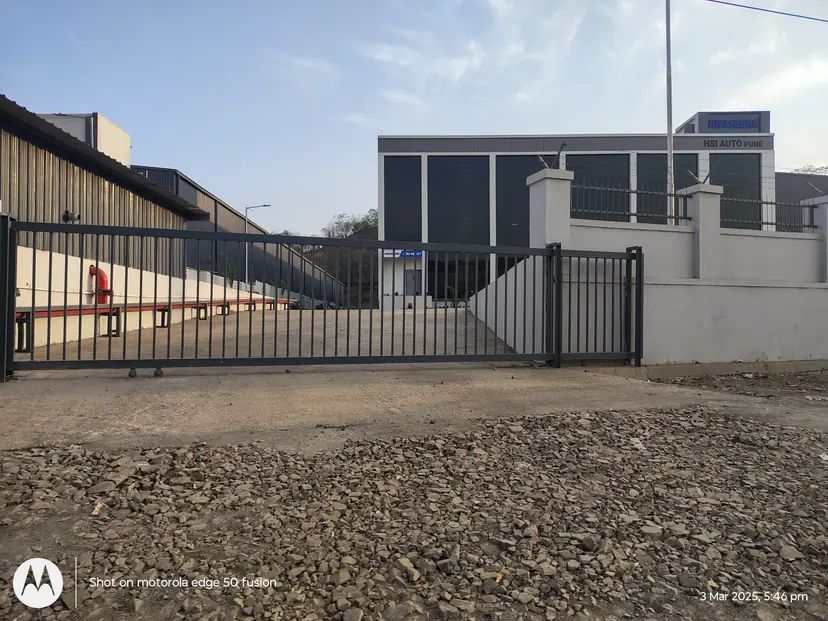 Fabricated steel sliding entrance gate and boundary railing at a completed facility
